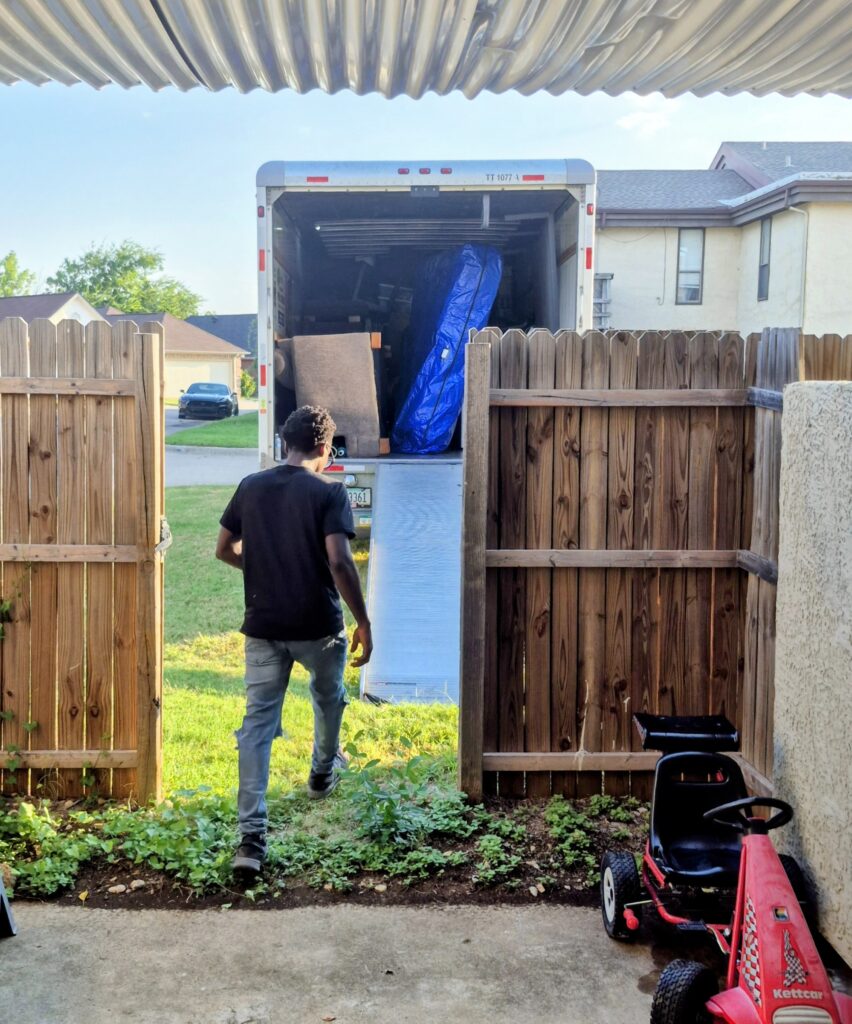 Apartment moving truck parked near apartment fence during a Fort Worth apartment move