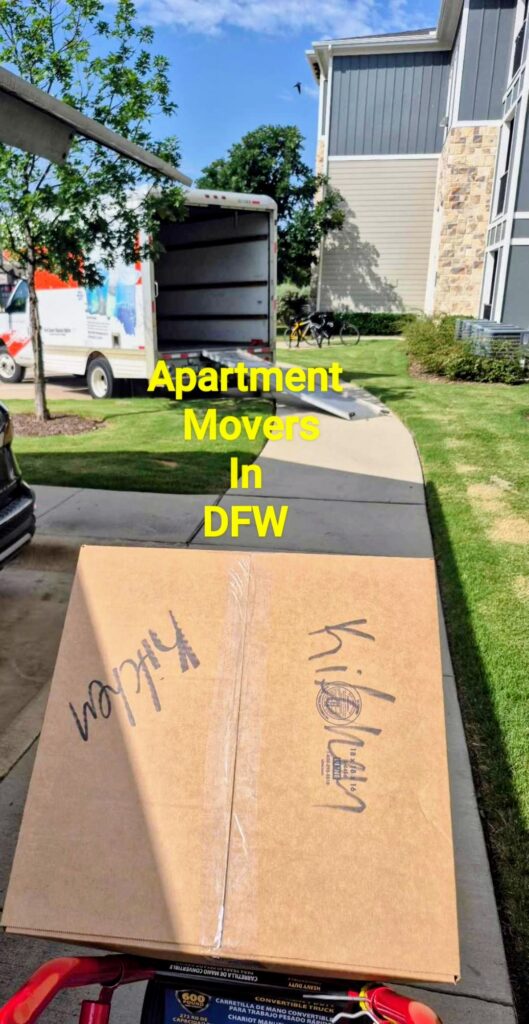 Professional apartment movers loading furniture into a moving truck in Roanoke, Texas.