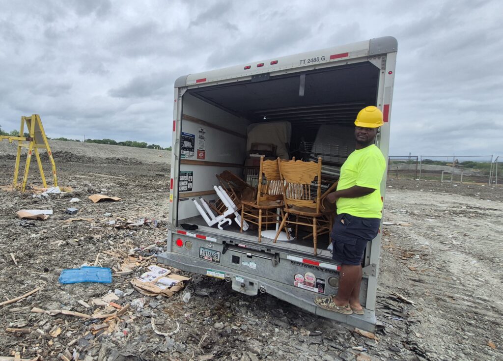 Junk removal team from Sky Is The Limit Moving unloading debris at a landfill in the Dallas-Fort Worth area