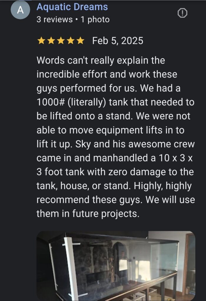 Large aquatic tank carefully lifted and placed onto stand during Aquatic Dreams move by Sky Is The Limit Moving
