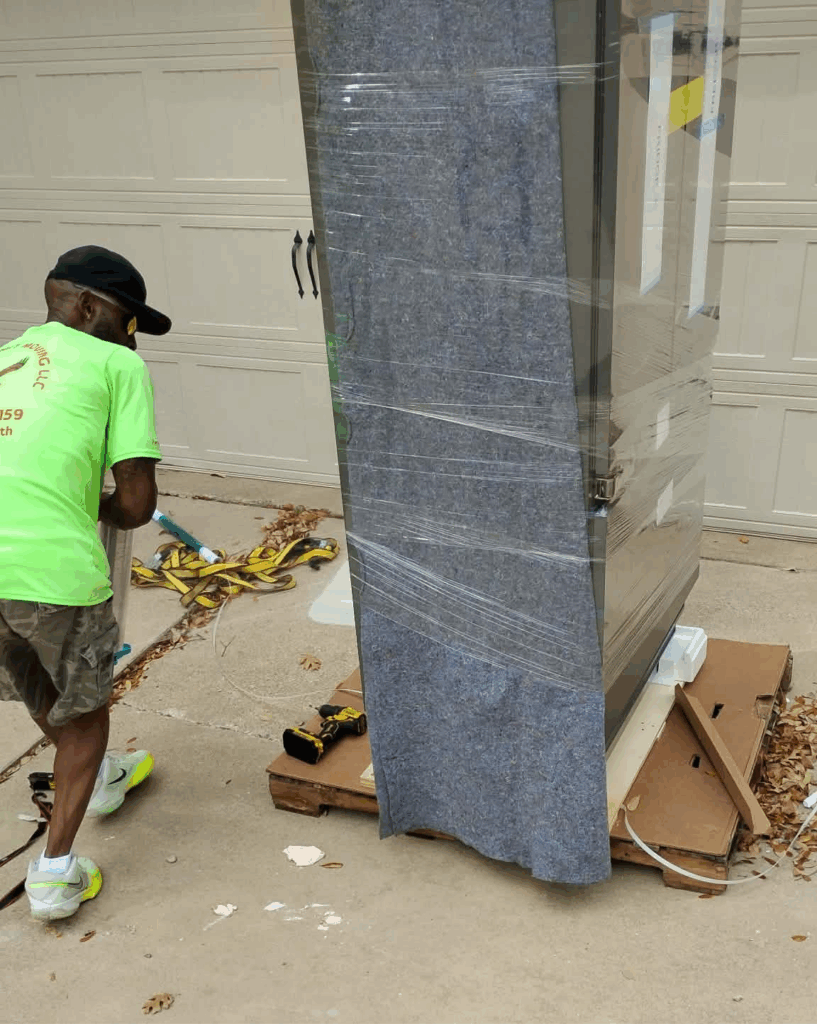 Sky wrapping a fridge for a safe move from the driveway through the front door and placed where the customer wants it in Fort Worth