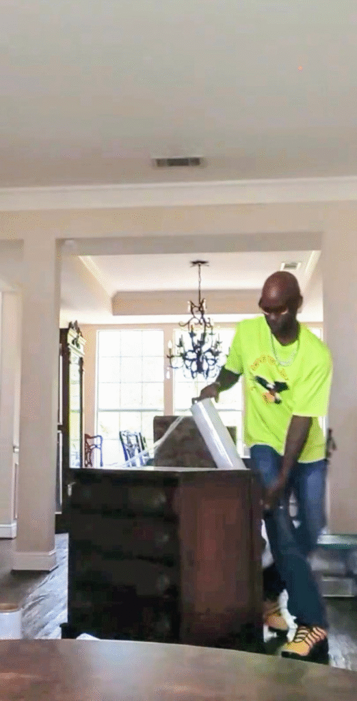 Sky Is The Limit Moving carefully wrapping a wooden dresser and nightstand with moving blankets and protective materials to prevent damage during transport.