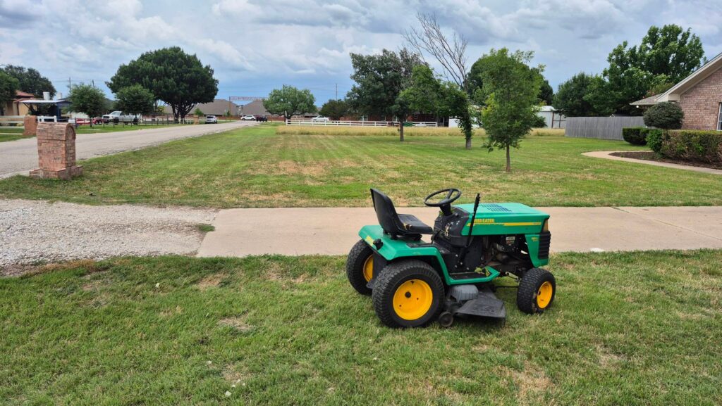 Skycare Lawncare riding mower cutting grass in a large residential yard in Fort Worth and Saginaw Texas lawn mowing service
